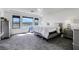 Spacious main bedroom featuring gray carpet, large windows and tray ceiling at 9045 Knots Estate St, Las Vegas, NV 89139