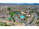 Aerial shot of the community amenities including a large pool, tennis courts, and lush landscaping at 985 Via Lombardi Ave, Henderson, NV 89011