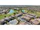 Stunning aerial view of the community showcasing its well-maintained streets, golf course, and lake at 985 Via Lombardi Ave, Henderson, NV 89011
