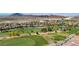 Expansive golf course community with well-maintained greens, lush landscaping, and stunning mountain views at 985 Via Lombardi Ave, Henderson, NV 89011