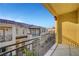 Exterior view from a balcony with decorative railings overlooking a beautifully landscaped courtyard at 985 Via Lombardi Ave, Henderson, NV 89011