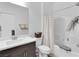 Bright bathroom featuring a shower-tub combo, vanity with drawers, toilet, and modern fixtures at 985 Via Lombardi Ave, Henderson, NV 89011