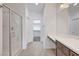 Bathroom featuring a glass shower, vanity with a sink, and a linen closet at 985 Via Lombardi Ave, Henderson, NV 89011