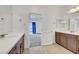 Bright bathroom with double vanity, sleek wood cabinets, and modern fixtures at 985 Via Lombardi Ave, Henderson, NV 89011