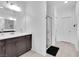 Bathroom with a large vanity, double sinks, and a glass-enclosed shower, creating a modern look at 985 Via Lombardi Ave, Henderson, NV 89011
