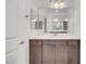 Bathroom featuring a single sink vanity with dark wood cabinets and chrome hardware at 985 Via Lombardi Ave, Henderson, NV 89011
