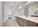 Bathroom showcasing double sinks, a large mirror, and a glass-enclosed shower at 985 Via Lombardi Ave, Henderson, NV 89011