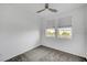 Bedroom with neutral carpet, ceiling fan, and two windows for natural light at 985 Via Lombardi Ave, Henderson, NV 89011