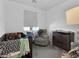 Cozy bedroom featuring a crib, comfortable chair, dresser, and a window with natural light at 985 Via Lombardi Ave, Henderson, NV 89011
