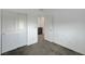 Carpeted bedroom with closet featuring ample storage space, and a doorway to additional rooms at 985 Via Lombardi Ave, Henderson, NV 89011