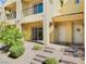 Charming townhome featuring a covered front porch and a well-maintained landscaped front yard at 985 Via Lombardi Ave, Henderson, NV 89011