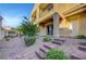 Inviting townhouse entrance with brick steps, desert landscaping, and charming curb appeal at 985 Via Lombardi Ave, Henderson, NV 89011