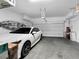 Attached two-car garage featuring storage racks and a parked vehicle, with an automatic door at 985 Via Lombardi Ave, Henderson, NV 89011