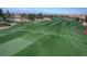 Lush green golf course with manicured fairways surrounded by mature trees and distant mountain views at 985 Via Lombardi Ave, Henderson, NV 89011