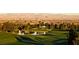 Picturesque golf course view with a tranquil pond, lush green fairways, and a stunning city skyline backdrop at 985 Via Lombardi Ave, Henderson, NV 89011