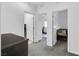 Bright hallway with neutral carpet with doorways to bedroom and laundry room, offering convenient living at 985 Via Lombardi Ave, Henderson, NV 89011