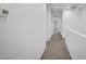 Upstairs hallway with neutral carpeting and walls, leading to various rooms in the home at 985 Via Lombardi Ave, Henderson, NV 89011