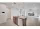 Stylish kitchen island with granite countertops, pendant lighting, and modern cabinetry at 985 Via Lombardi Ave, Henderson, NV 89011