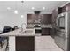 Stylish kitchen featuring stainless steel appliances, granite countertops, and a central island at 985 Via Lombardi Ave, Henderson, NV 89011