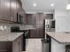 Modern kitchen with stainless steel appliances and granite countertops at 985 Via Lombardi Ave, Henderson, NV 89011