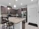 Modern kitchen with granite countertops, stainless steel appliances, and a stylish island with bar seating at 985 Via Lombardi Ave, Henderson, NV 89011