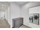 Hallway leading to laundry room featuring modern washer and dryer units at 985 Via Lombardi Ave, Henderson, NV 89011