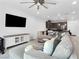 Bright living room with a large TV and comfortable sectional sofa at 985 Via Lombardi Ave, Henderson, NV 89011
