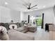 Bright living room with sliding glass door and comfortable sectional sofa at 985 Via Lombardi Ave, Henderson, NV 89011