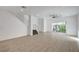 Bright living area with tile floors, a staircase, and sliding glass doors to outdoor patio at 985 Via Lombardi Ave, Henderson, NV 89011