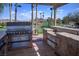 Built-in outdoor kitchen with grill, counter space, and scenic views of the golf course at 985 Via Lombardi Ave, Henderson, NV 89011