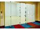 Modern indoor squash court with glass walls and wood flooring at 985 Via Lombardi Ave, Henderson, NV 89011