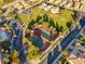 Aerial view of meticulously maintained community tennis courts nestled among mature trees and green spaces at 985 Via Lombardi Ave, Henderson, NV 89011