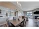 Open concept dining area with modern lighting flowing into living room and kitchen at 9901 Trailwood Dr # 2109, Las Vegas, NV 89134