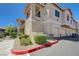 Exterior view of townhomes with garages and well-maintained landscaping on a sunny day at 9901 Trailwood Dr # 2109, Las Vegas, NV 89134