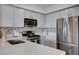 Bright kitchen with stainless steel appliances, light countertops and mosaic backsplash at 9901 Trailwood Dr # 2109, Las Vegas, NV 89134
