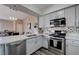 Open kitchen view, stainless steel appliances, flowing into dining area at 9901 Trailwood Dr # 2109, Las Vegas, NV 89134