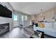 Open living room with fireplace, balcony access, modern flooring and a comfortable seating arrangement at 9901 Trailwood Dr # 2109, Las Vegas, NV 89134