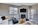 Bright living room featuring a modern fireplace, large window, and comfortable seating area at 9901 Trailwood Dr # 2109, Las Vegas, NV 89134