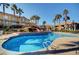 Community pool features inviting blue water, tropical landscaping, and plenty of space to lounge at 9901 Trailwood Dr # 2109, Las Vegas, NV 89134
