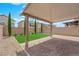 Secluded backyard with artificial turf, a brick-paved patio, and gravel accents, ideal for entertaining at 10029 Cluny Ave, Las Vegas, NV 89178