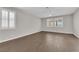 Bright bedroom with wood-look tile flooring, ceiling fan, and shuttered windows at 10029 Cluny Ave, Las Vegas, NV 89178