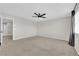 Spacious bedroom featuring neutral walls, plush carpeting, and a modern ceiling fan at 10029 Cluny Ave, Las Vegas, NV 89178