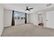 Spacious bedroom with carpeting, ceiling fan, and large windows offering plenty of natural light at 10029 Cluny Ave, Las Vegas, NV 89178