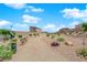 Neighborhood park features a walking path, bench, and pet waste station, set against a backdrop of desert landscaping and blue skies at 10029 Cluny Ave, Las Vegas, NV 89178