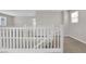 Hallway with white railings and carpet, offering a bright and airy passage at 10029 Cluny Ave, Las Vegas, NV 89178