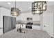 This bright kitchen includes stainless appliances, granite counters, and modern light fixtures at 10029 Cluny Ave, Las Vegas, NV 89178