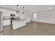 Modern kitchen with white cabinets, granite countertops, stainless steel appliances, and pendant lighting at 10029 Cluny Ave, Las Vegas, NV 89178