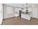 Kitchen boasts stainless appliances, white cabinets, granite counters, and stylish pendant lighting at 10029 Cluny Ave, Las Vegas, NV 89178