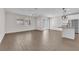 Open-concept living area with hardwood floors, ample natural light, and view of the kitchen at 10029 Cluny Ave, Las Vegas, NV 89178