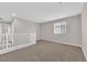 Bright, neutral-toned loft space featuring plush carpeting and a window, offering versatile living area at 10029 Cluny Ave, Las Vegas, NV 89178